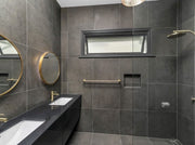 Modern Round Brass Mirror, in  a bathroom