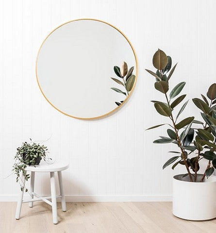 Modern Round Brass Mirror, in a room