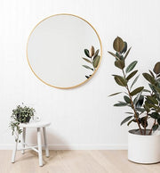 Modern Round Brass Mirror, in a room
