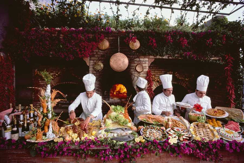 Kitchen staff preparing a feast at Il San Pietro di Positano Hotel, Italy, 1984 — Slim Aarons